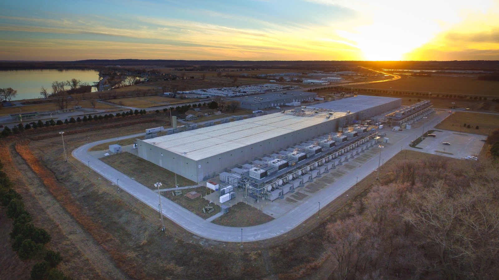 Aerial view of a hyperscale data center building surrounded by open farmland